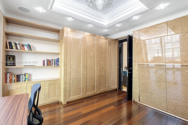 home office with crown molding, dark wood-type flooring, and a tray ceiling