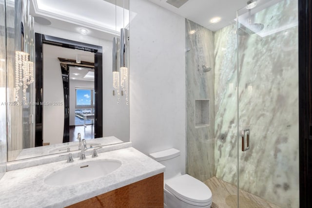 bathroom featuring vanity, toilet, and a shower with shower door