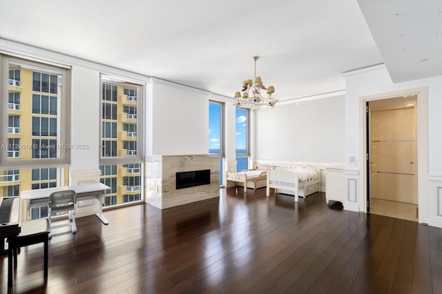 sitting room featuring an inviting chandelier, a premium fireplace, and dark hardwood / wood-style floors