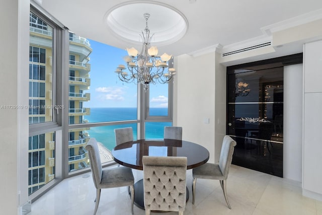 tiled dining space featuring ornamental molding, a water view, an inviting chandelier, and a tray ceiling