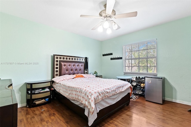 bedroom featuring ceiling fan and dark hardwood / wood-style floors