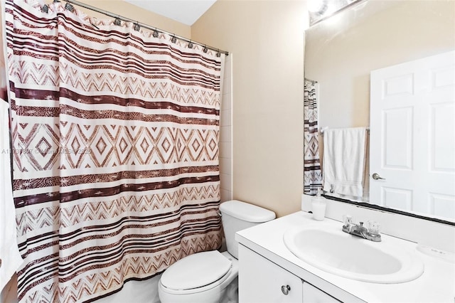 bathroom with vanity, curtained shower, and toilet