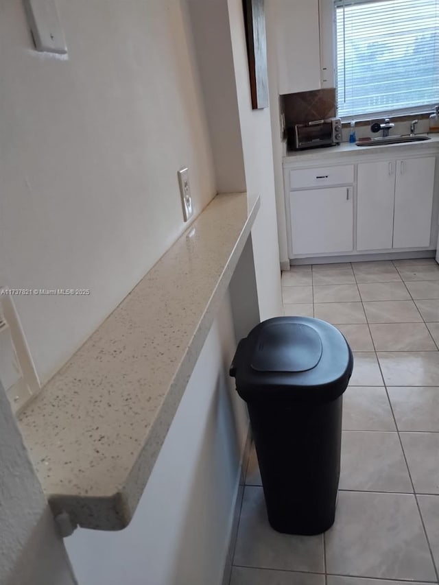 bathroom featuring sink, backsplash, and tile patterned floors