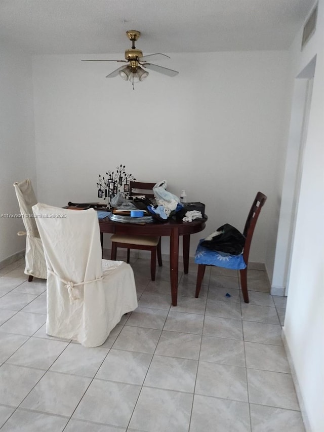 dining area with ceiling fan and light tile patterned floors