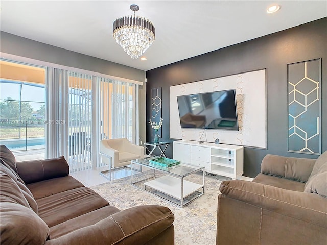 living room with tile patterned flooring and an inviting chandelier