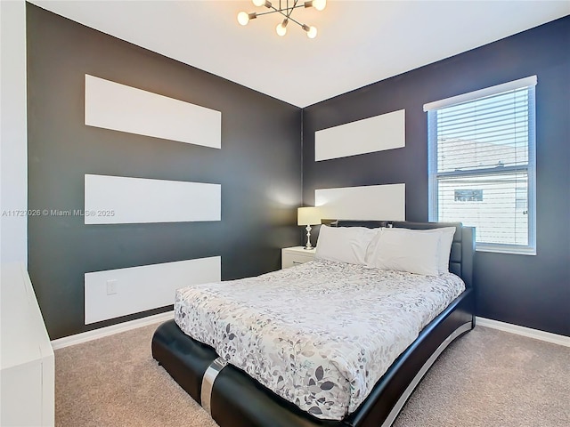 bedroom with an inviting chandelier and carpet