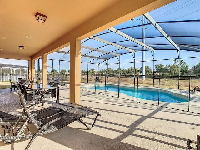 view of pool featuring a patio and glass enclosure