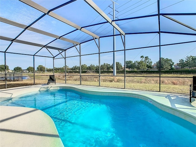 view of pool with a patio and glass enclosure