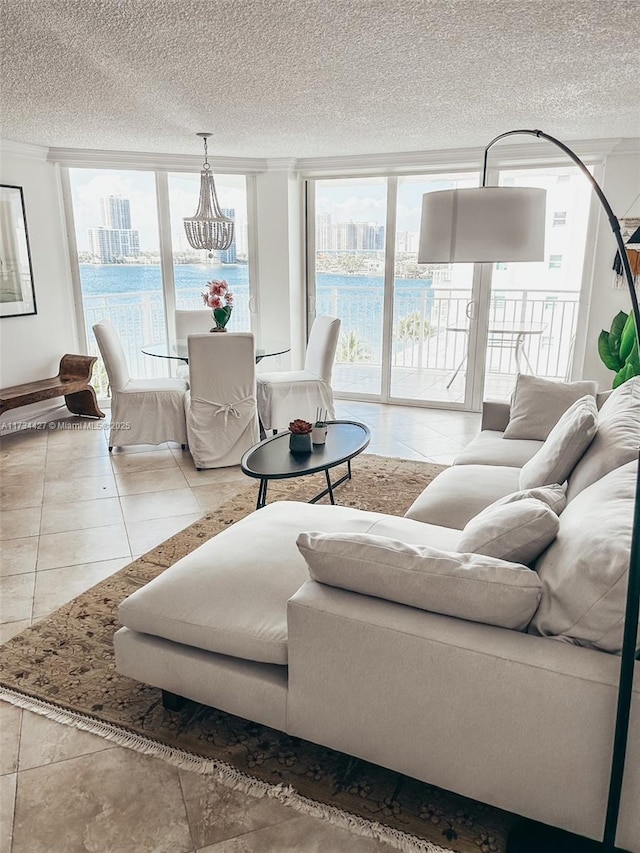 tiled living room with expansive windows, a textured ceiling, and a healthy amount of sunlight