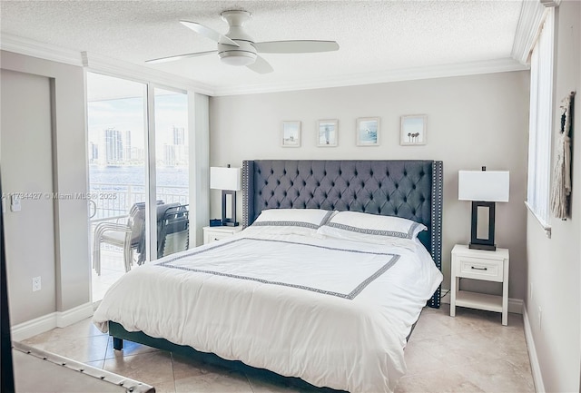 bedroom featuring a textured ceiling, ceiling fan, expansive windows, and ornamental molding