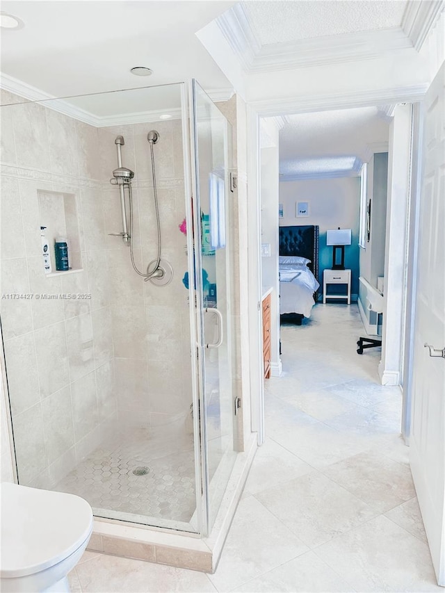 bathroom with toilet, ornamental molding, and a shower with door