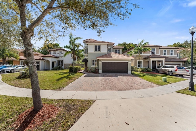 mediterranean / spanish-style home with a garage and a front lawn