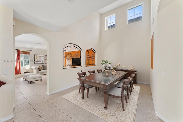 tiled dining area featuring a high ceiling