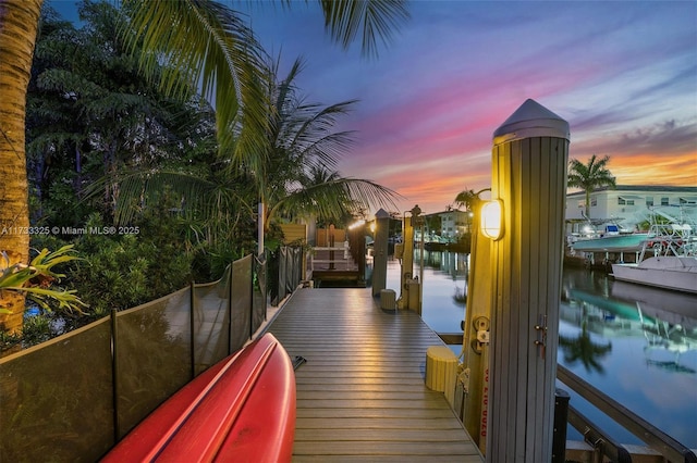 view of community featuring a water view and a dock