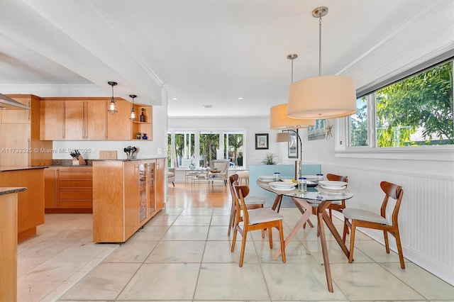 dining room with ornamental molding, a wealth of natural light, and light tile patterned floors