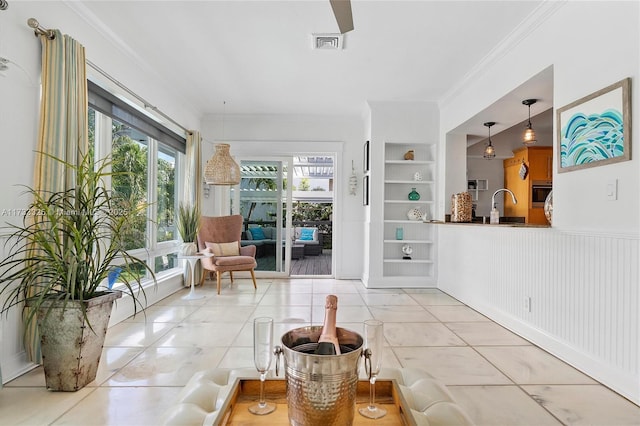 sunroom featuring visible vents and a sink