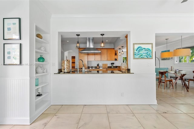 kitchen featuring hanging light fixtures, built in shelves, island exhaust hood, and open shelves