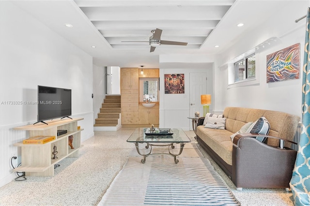 living area featuring light speckled floor, recessed lighting, stairway, a ceiling fan, and beamed ceiling