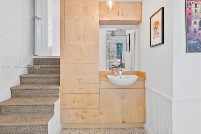 bathroom with wainscoting, vanity, and speckled floor