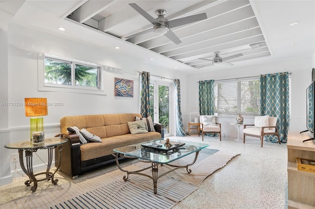 living area featuring light speckled floor, recessed lighting, a wainscoted wall, visible vents, and a ceiling fan