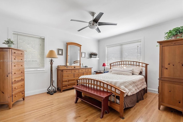 bedroom with baseboards, ornamental molding, a ceiling fan, and light wood-style floors