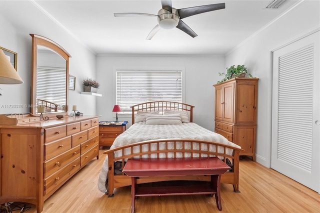 bedroom featuring ornamental molding, visible vents, and light wood-style floors