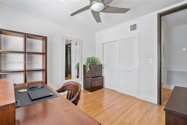 office space featuring ceiling fan, ornamental molding, visible vents, and light wood-style floors