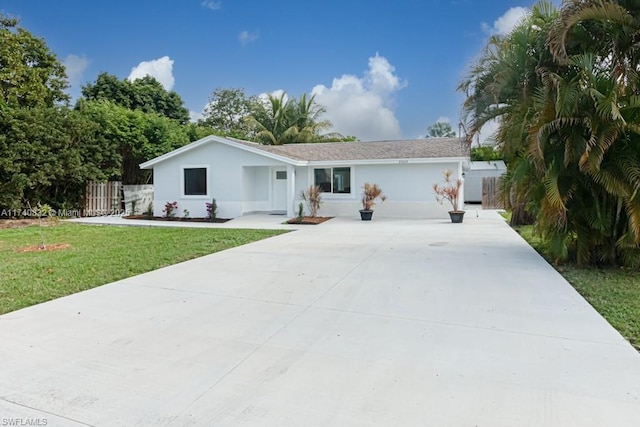 ranch-style home with a garage and a front lawn