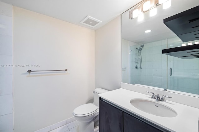 bathroom featuring toilet, vanity, tile patterned flooring, and a shower with shower door