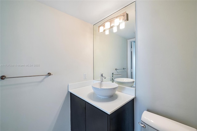 bathroom with toilet and vanity