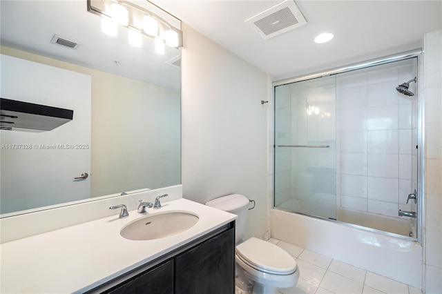 full bathroom featuring tile patterned floors, vanity, toilet, and enclosed tub / shower combo