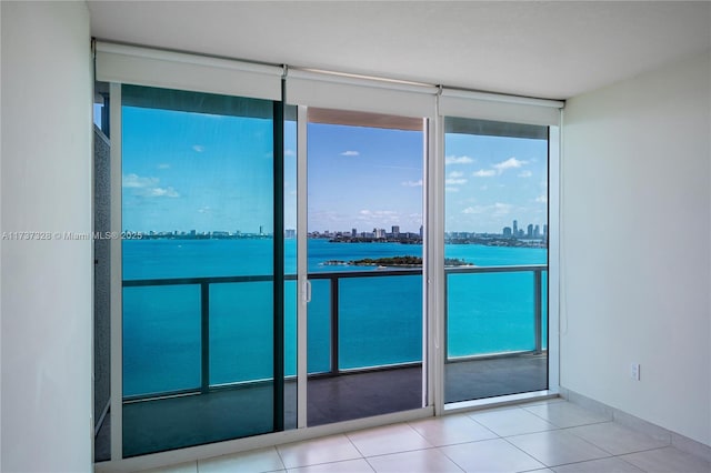 interior space with light tile patterned flooring and a wall of windows