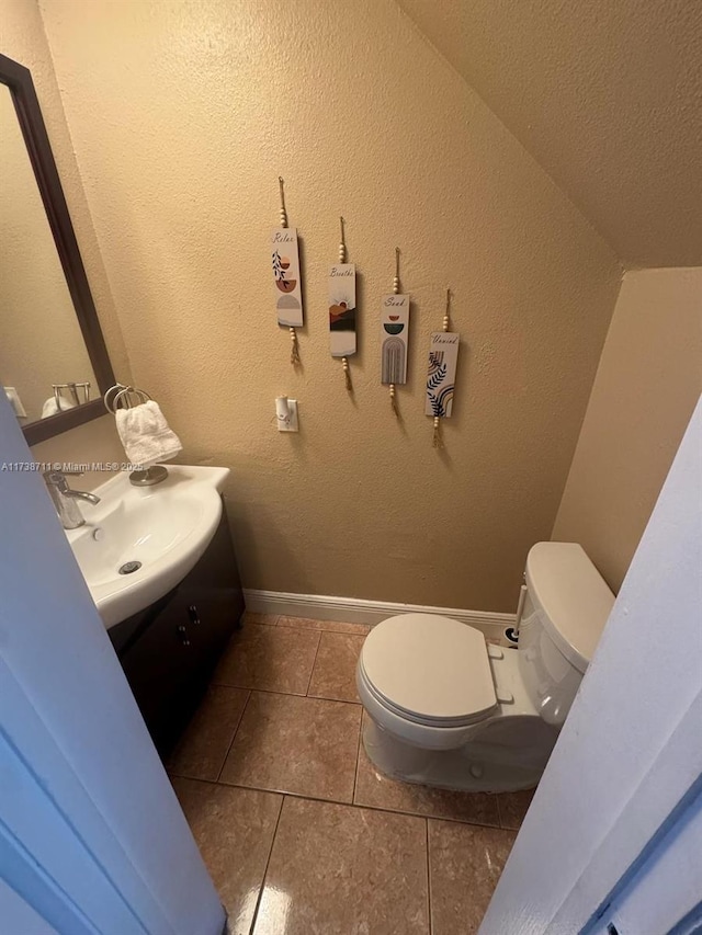 bathroom featuring vanity, tile patterned floors, and toilet