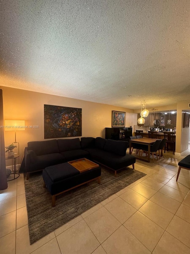 tiled living room featuring a textured ceiling