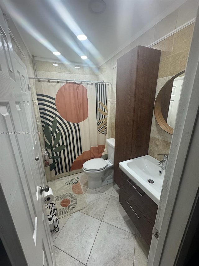 bathroom featuring tile walls, vanity, toilet, and a shower with shower curtain