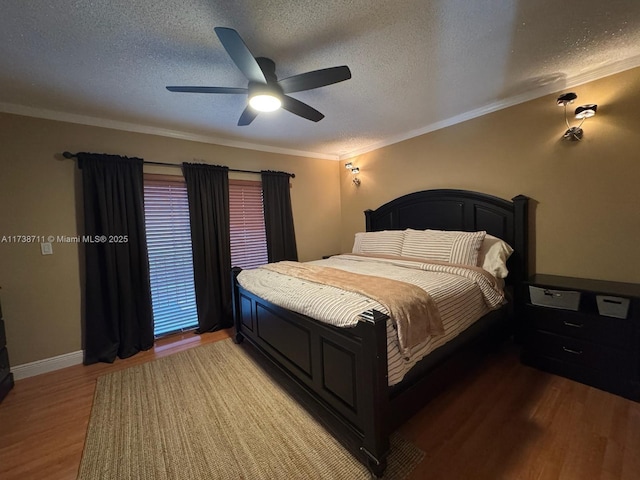 bedroom with hardwood / wood-style flooring, ornamental molding, and a textured ceiling