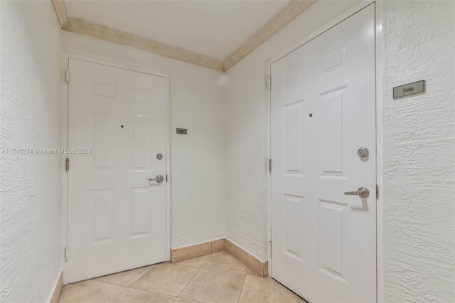 foyer entrance with light tile patterned floors