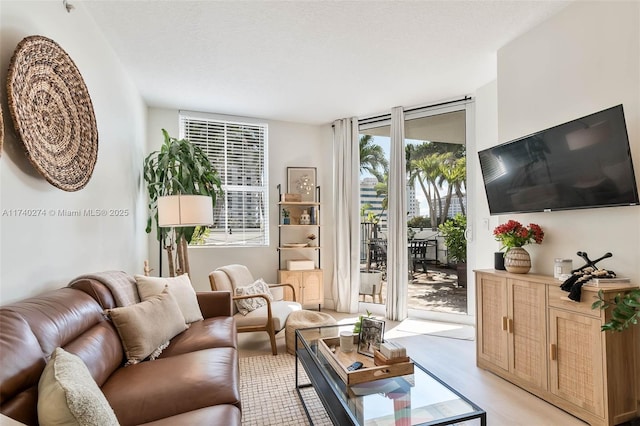 living room featuring floor to ceiling windows and a textured ceiling