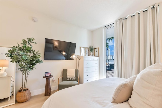 bedroom featuring access to outside and light hardwood / wood-style floors