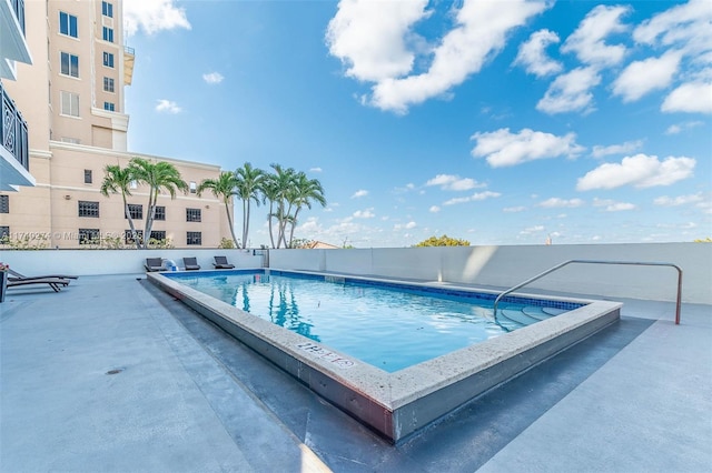 view of swimming pool featuring a patio area