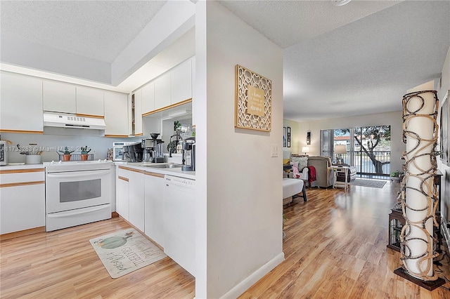 kitchen featuring sink, white cabinetry, light hardwood / wood-style flooring, a textured ceiling, and white appliances