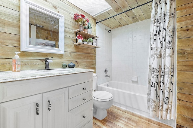 full bathroom featuring toilet, wood ceiling, wood-type flooring, vanity, and shower / bath combo