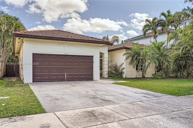 mediterranean / spanish-style house featuring a garage and a front lawn