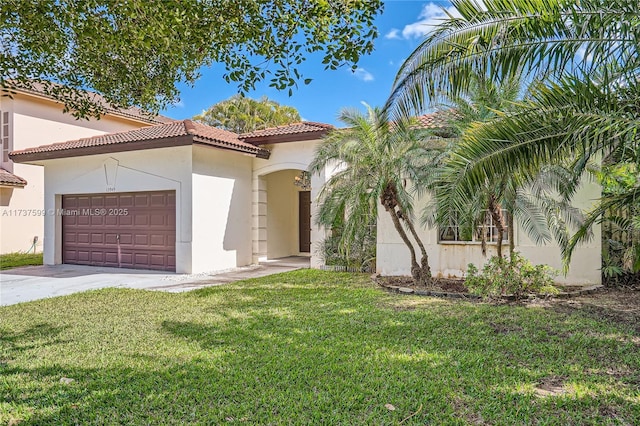 mediterranean / spanish-style house featuring a garage and a front yard