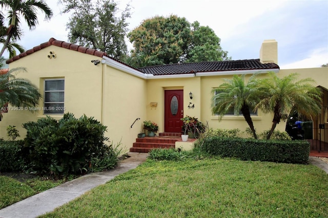 mediterranean / spanish house with a front lawn