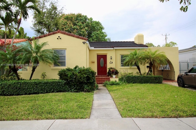 mediterranean / spanish house featuring a front yard