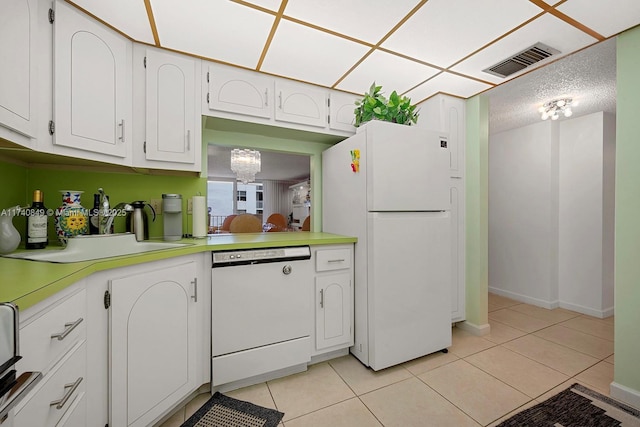 1865 S Ocean Dr Unit 4D, Hallandale Beach, FL 33009 - kitchen featuring white cabinetry, light tile patterned flooring, a textured ceiling, and white appliances