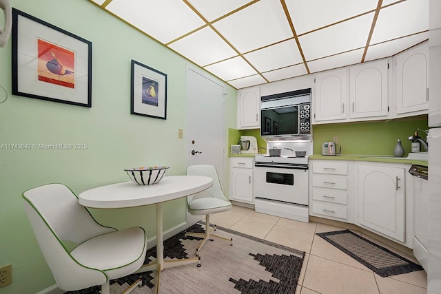 1865 S Ocean Dr Unit 4D, Hallandale Beach, FL 33009 - kitchen featuring white cabinetry, light tile patterned floors, and white electric range oven