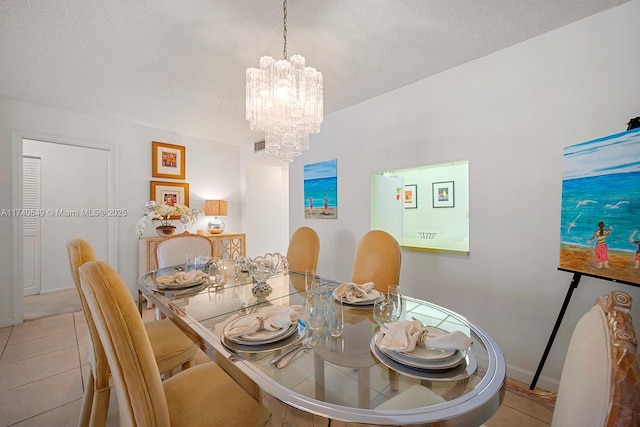1865 S Ocean Dr Unit 4D, Hallandale Beach, FL 33009 - tiled dining space featuring a notable chandelier and a textured ceiling
