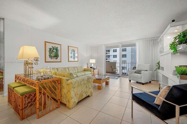 1865 S Ocean Dr Unit 4D, Hallandale Beach, FL 33009 - tiled living room with expansive windows and a textured ceiling